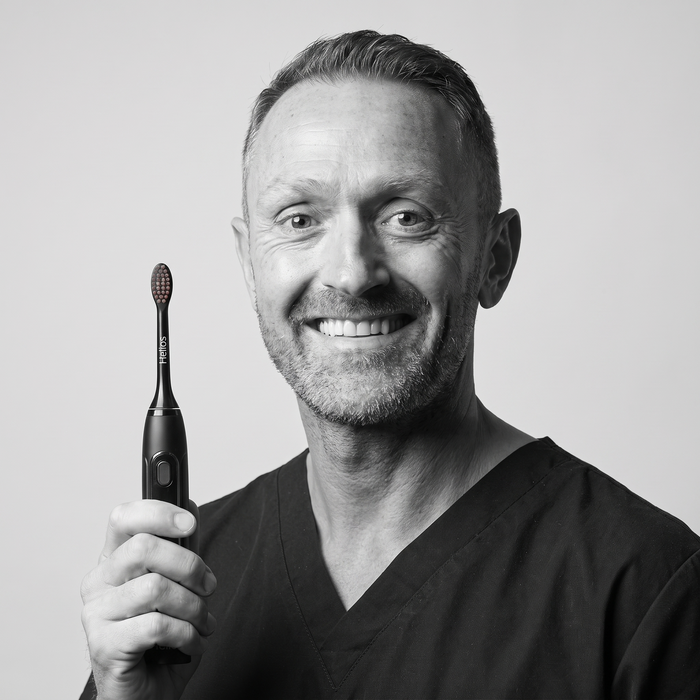 Dental professional holding the Helios toothbrush