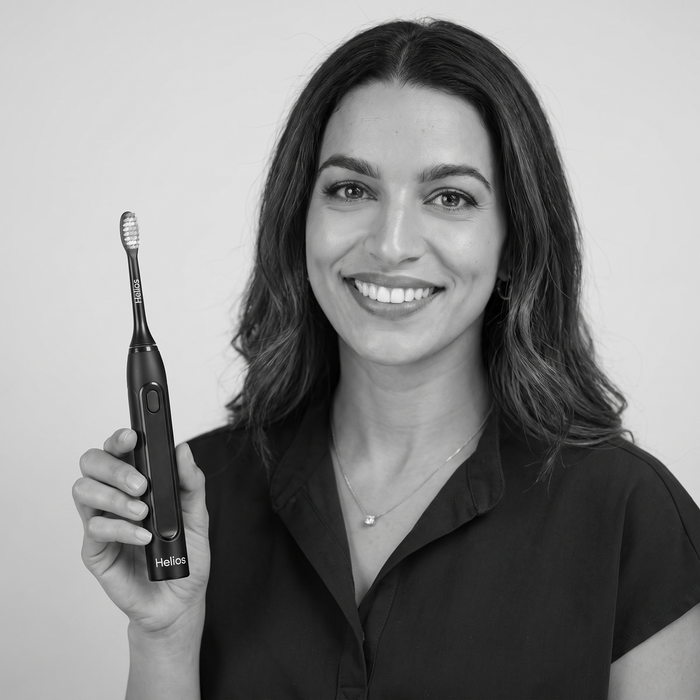 Dental professional holding the Helios toothbrush