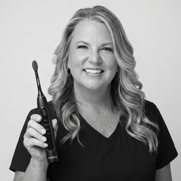Dental professional holding the Helios toothbrush