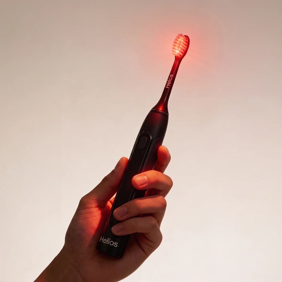 Helios toothbrush held securely in one hand with the brush head illuminated