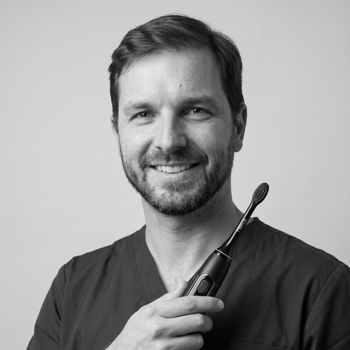 Dental professional holding the Helios toothbrush